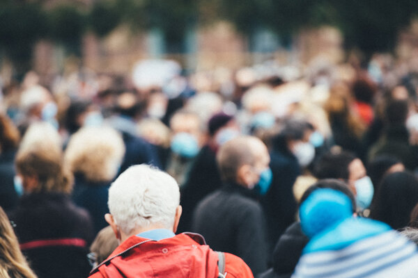 Bild vergr&ouml;&szlig;ern: Rear view of people gathering at a protest all of them wearing protective masks due to COVID-19 coronavirus epidemic situation
